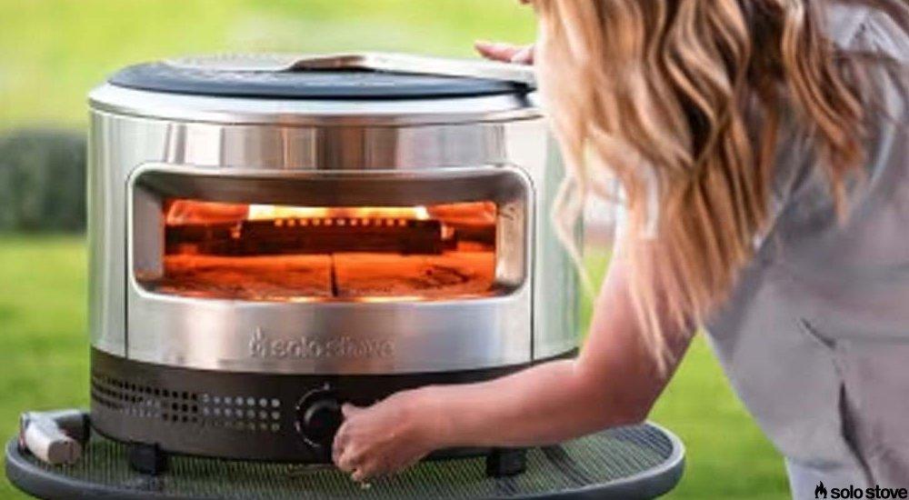 women turning on a pizza oven